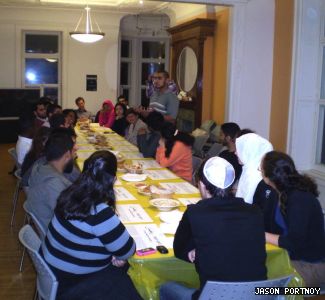 Students gathered at Hillel House to share traditions. Standing is Muslim Students Association president Abdullah Hasen, welcoming guests. Behind him (obscured) is Hillel Concordia president Mitchell Sohmer.